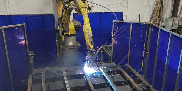 Robotic welding cell welding steel parts at FAB Parts USA